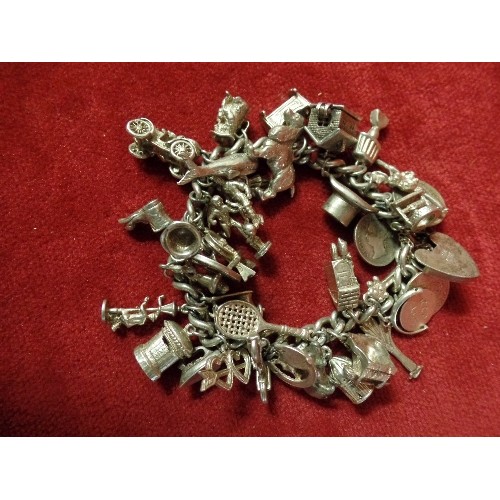 37 - SILVER HALLMARKED CHARM BRACELET WITH LARGE AMOUNT OF SILVER CHARMS 107.72G