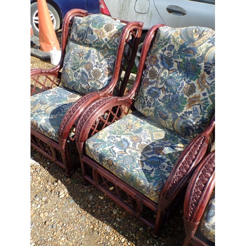 415 - 4 X LARGE DARK CANE GARDEN ARMCHAIRS. DEEP UPHOLSTERED SQUARE CUSHION PADS IN ATTRACTIVE PATTERNED F... 