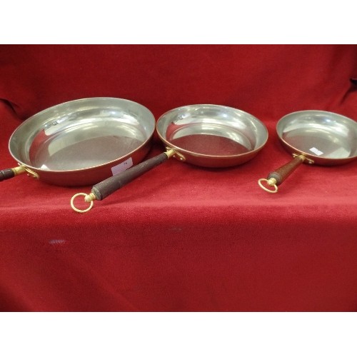 78 - 3 X GRADUATED COPPER PANS, WOODEN HANDLES WITH HANGING LOOPS. MADE IN PORTUGAL.