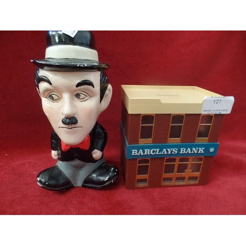 127 - 2 X VINTAGE MONEY BOXES. BARCLAYS BANK, AND CHARLIE CHAPLIN.