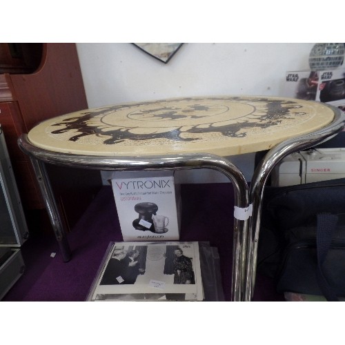 143 - RETRO CIRCULAR COFFEE TABLE. TUBULAR CHROME FRAME. TOP HAS GALLOPING HORSES CIRCLING THE TOP.