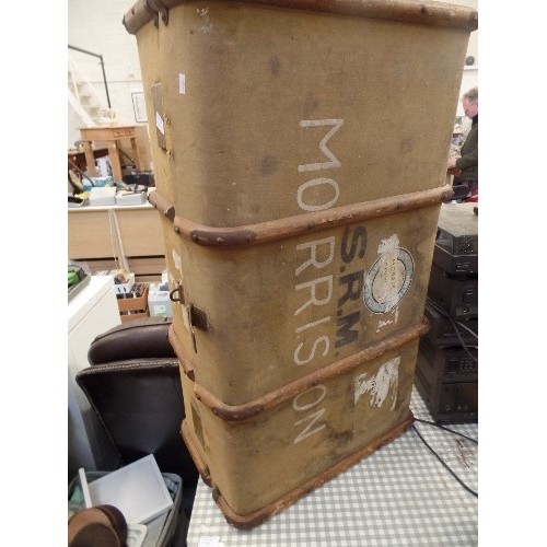 564 - LARGE VINTAGE CANVAS TRUNK, WITH WOODEN BANDING. IN A DULL MUSTARD COLOUR.