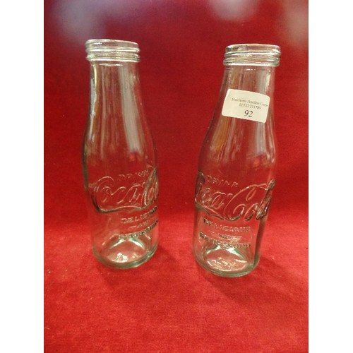 92 - PAIR OF VINTAGE GLASS COCA-COLA BRANDED PINT BOTTLES.