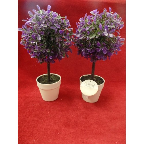 114 - PAIR OF SMALL PURPLE FAUX PLANTS IN WHITE POTS.