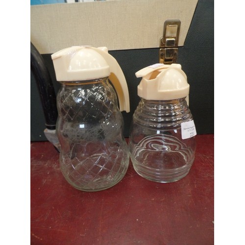 223 - PAIR OF VINTAGE 'HYGENE POURERS' GLASS WITH SPRUNG PLASTIC POURER LIDS.