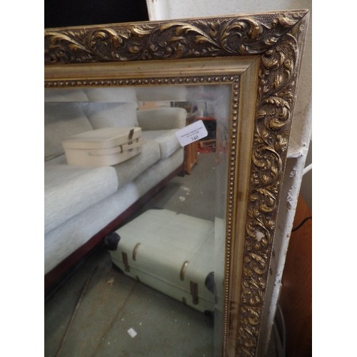 340 - GILT-FRAMED BEVELLED MIRROR. RECTANGULAR.