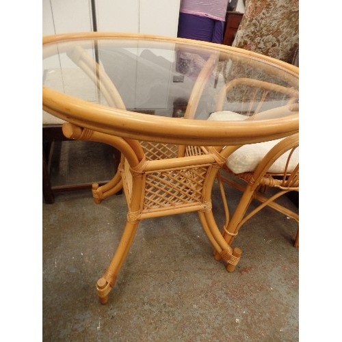 397 - CANE AND GLASS CONSERVATORY TABLE, APPROX 85CM DIAM, ALSO 1 CHAIR WITH DEEP GINGHAM SEAT PAD.