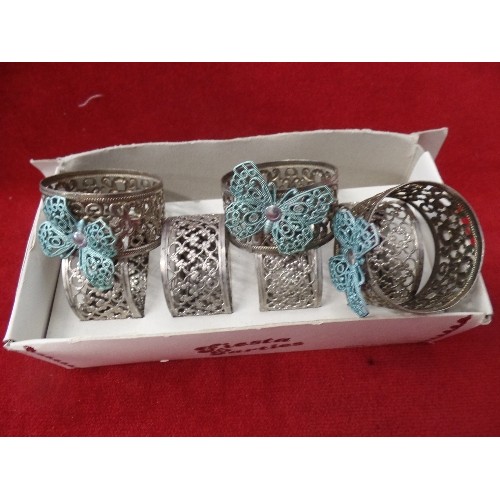 112 - QUANTITY OF NAPKIN RINGS - 4 WOODEN ONES WITH WINE BOTTLE FEATURE, 6 FILIGREE METAL, SOME WITH BUTTE... 