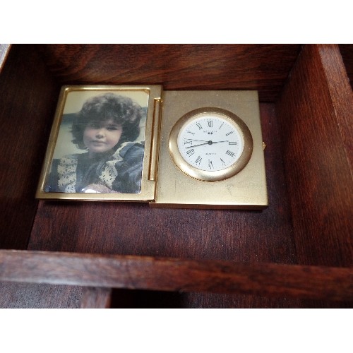 202 - 24 MINIATURE BRASS CLOCKS IN A WOODEN DISPLAY CASE