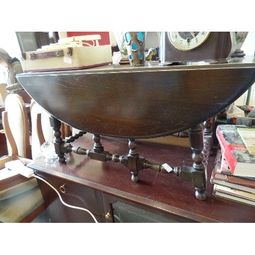 362 - ERCOL DROP-LEAF COFFEE TABLE. DARK WOOD. TURNED BASE AND LEGS.