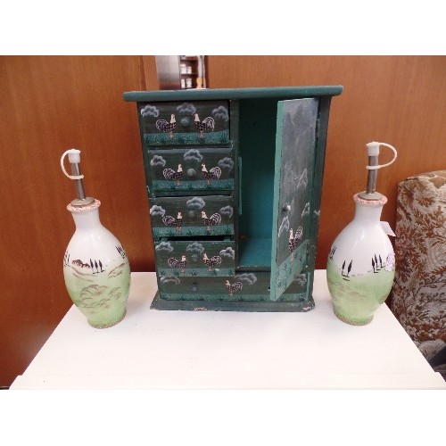 401 - PAIR OF CERAMIC OIL & VINEGAR DECANTERS, AND A MINIATURE  WOODEN CABINET DECORATED WITH ROOSTERS.