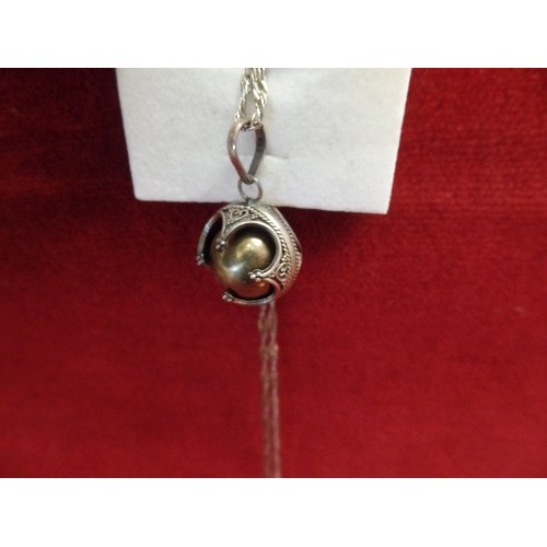 12 - A SILVER CHINESE VIBRATING BALL ON SILVER CHAIN