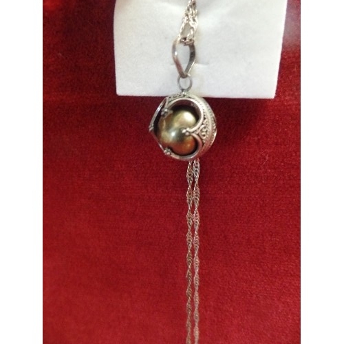 12 - A SILVER CHINESE VIBRATING BALL ON SILVER CHAIN