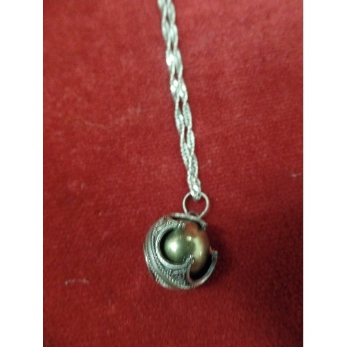 12 - A SILVER CHINESE VIBRATING BALL ON SILVER CHAIN