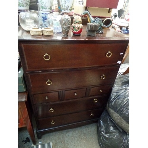 414 - STAG MINSTREL TALL CHEST OF DRAWERS. DARK WOOD WITH BRASS HANDLES.