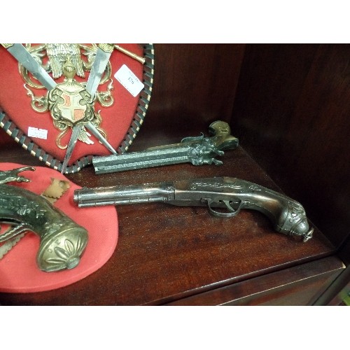 426 - 5 X VINTAGE REPLICA PISTOLS AND A HERALDIC COAT OF ARMS PLAQUE. .