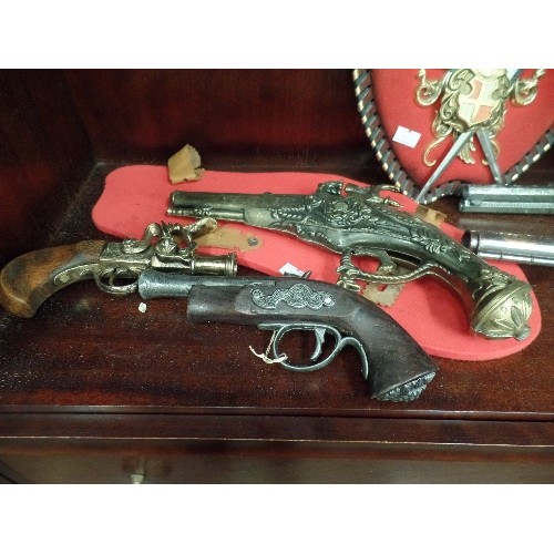 426 - 5 X VINTAGE REPLICA PISTOLS AND A HERALDIC COAT OF ARMS PLAQUE. .