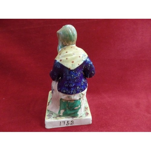 8 - A STAFFORDSHIRE EARTHENWARE FIGURE OF DOLLY PENTREATH ON A SQUARE BASE - MARKED 1753 TO BACK. SAID T... 