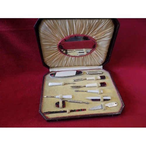 41 - AN ART DECO CASED MANICURE SET WITH COLOURED BAKELITE TOOLS