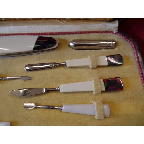 41 - AN ART DECO CASED MANICURE SET WITH COLOURED BAKELITE TOOLS