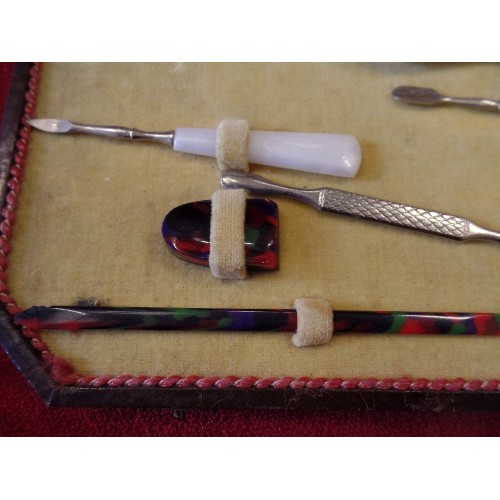 41 - AN ART DECO CASED MANICURE SET WITH COLOURED BAKELITE TOOLS