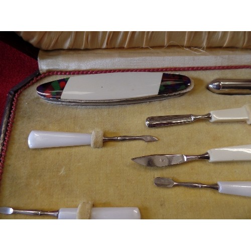 41 - AN ART DECO CASED MANICURE SET WITH COLOURED BAKELITE TOOLS