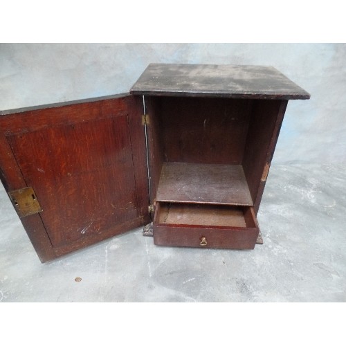 102 - A VICTORIAN OAK SMOKERS CABINET WITH INTERAL DRAWER AND CARVED DOOR