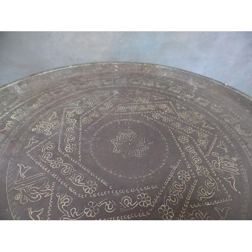 222 - A VINTAGE BENARES TABLE WITH FOLDING BASE AND PERSIAN BRASS TRAY TOP ENGRAVED WITH SCRIPT AND ANIMAL... 