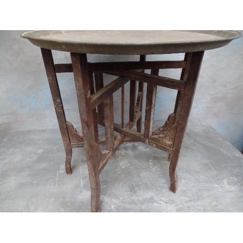 222 - A VINTAGE BENARES TABLE WITH FOLDING BASE AND PERSIAN BRASS TRAY TOP ENGRAVED WITH SCRIPT AND ANIMAL... 