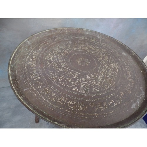 222 - A VINTAGE BENARES TABLE WITH FOLDING BASE AND PERSIAN BRASS TRAY TOP ENGRAVED WITH SCRIPT AND ANIMAL... 