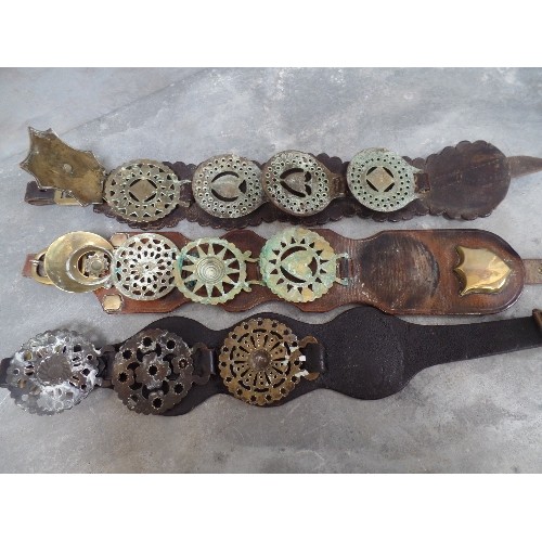 451 - THREE ANTIQUE MARTINGALES WITH SOME 19TH CENTURY BRASSES. INCLUDES A HANDSOME BROWN LEATHER STRAP WI... 