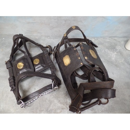 399 - TWO ANTIQUE LEATHER BRIDLES WITH BRASS STUDS TO THE BLINKERS, ONE WITH STUDDED BROWBAND, ONE WITH IR... 