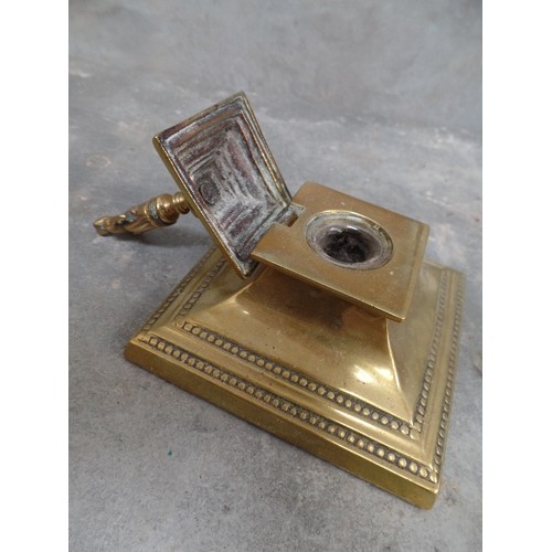 46 - VICTORIAN BRASS DESK INKWELL WITH GLASS INSERT. THE LID WITH A FINIAL OF A LADY - PROBABLY A DICKENS... 