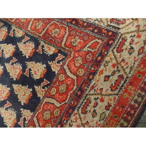 146A - ANTIQUE PERSIAN RUG, THE CENTRAL PANEL WITH TRADITIONAL BOTEH PATTERN AGAINST A DARK BLUE GROUND. 13... 