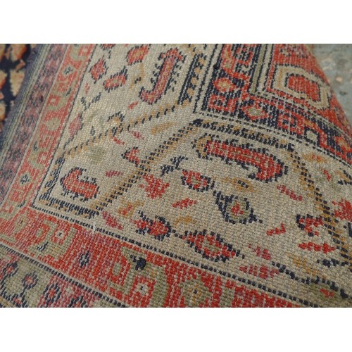 146A - ANTIQUE PERSIAN RUG, THE CENTRAL PANEL WITH TRADITIONAL BOTEH PATTERN AGAINST A DARK BLUE GROUND. 13... 