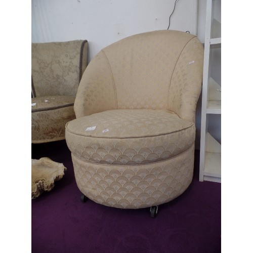 105 - A BEDROOM TUB CHAIR WITH SHELL DESIGN UPHOLSTERY ON BAKELITE CASTERS