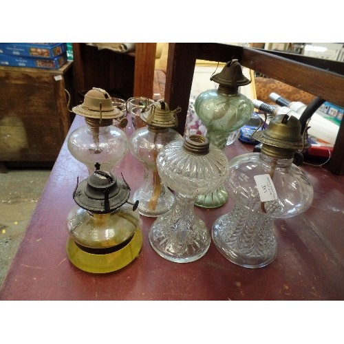 285 - 6 X VINTAGE GLASS OIL LAMPS. 1 STILL CONTAINS OIL.