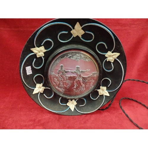 324 - RETRO UNUSUAL LAMP WITH  WROUGHT IRON SURROUND AND A SILVER CENTRAL DISC WITH 2 EMBOSSED 2 FIGURES F... 