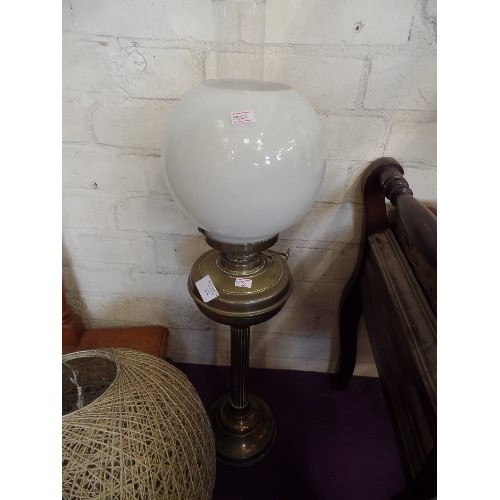 168 - A TALL VINTAGE OIL LAMP, WITH BRASS COLUMN & RESERVOIR, AND A MILK-GLASS GLOBE.
