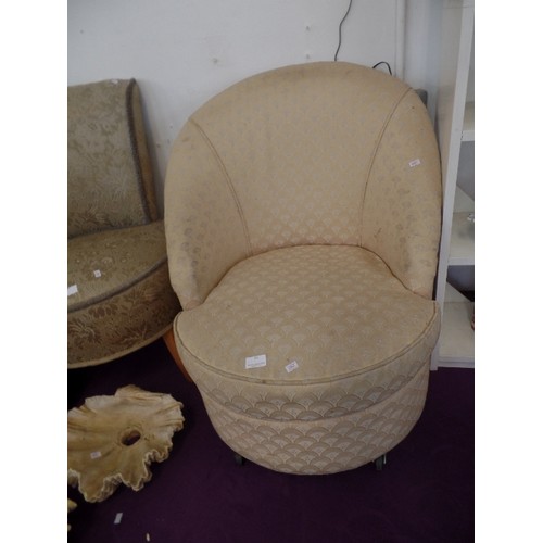 96 - A BEDROOM TUB CHAIR WITH SHELL DESIGN UPHOLSTERY ON BAKELITE CASTERS