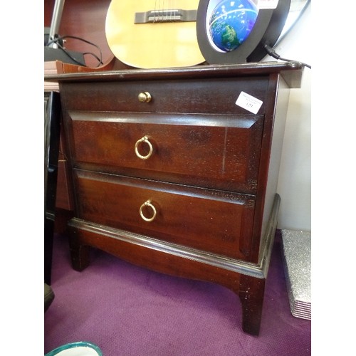 129 - STAG MINSTREL  BEDSIDE CABINET. 2 DRAWER, AND A PULL-OUT FLAT SURFACE.