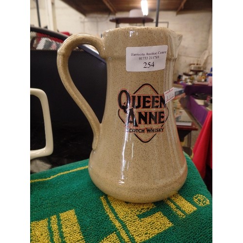 254 - 4 X BRANDED ADVERTISING WHISKY & STOUT JUGS AND A BAR TOWEL. INCLUDES TRENT BREWERY, QUEENE ANNE, SI... 