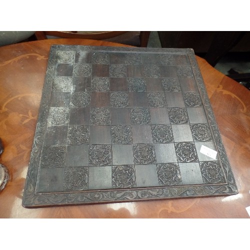 411 - LARGE CARVED WOODEN CHESS BOARD, WITH TUDOR-ROSE DETAIL, WITH BAIZE BACKING.