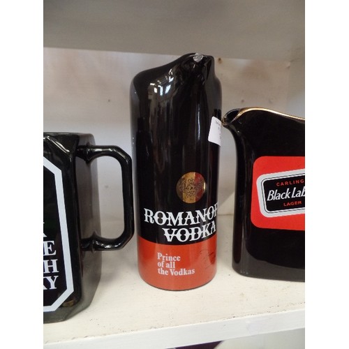 74 - 4 BRANDED WHISKY. VODKA AND LARGER JUGS. BLACK CERAMIC. INC ROMANOFF VODKA, TENNENTS LARGER, BLACK B... 