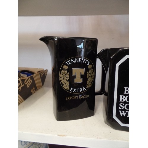 74 - 4 BRANDED WHISKY. VODKA AND LARGER JUGS. BLACK CERAMIC. INC ROMANOFF VODKA, TENNENTS LARGER, BLACK B... 