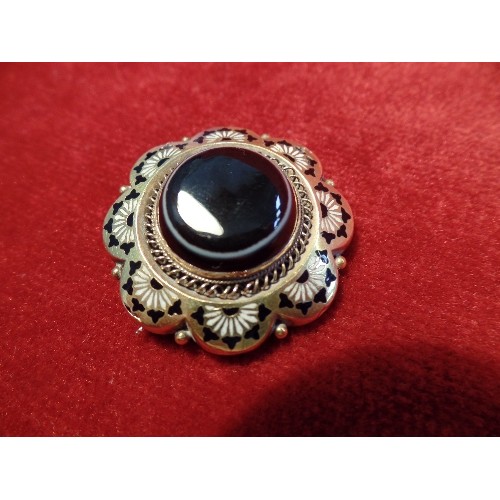 54 - A FINE QUALITY FLOWER SHAPED GOLD AND BLACK ENAMEL MOURNING BROOCH SET WITH A BULLS EYE AGATE STONE,... 