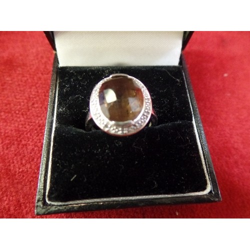 36 - A 9CT WHITE GOLD RING WITH LARGE SMOKEY QUARTZ SURROUNDED BY DIAMOND CHIPS - SIZE O