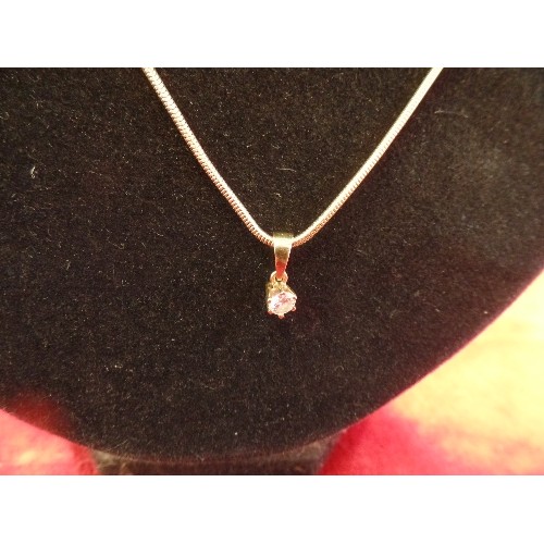 38 - A DIAMOND SOLITAIRE PENDANT (.25 CARAT) WITH 18CT GOLD SETTING AND BALE ON A SILVER GILT SNAKE CHAIN... 