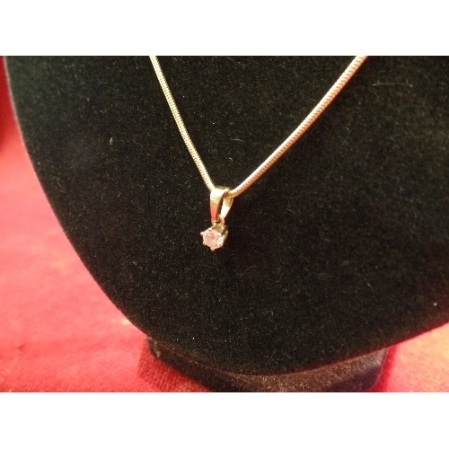 38 - A DIAMOND SOLITAIRE PENDANT (.25 CARAT) WITH 18CT GOLD SETTING AND BALE ON A SILVER GILT SNAKE CHAIN... 