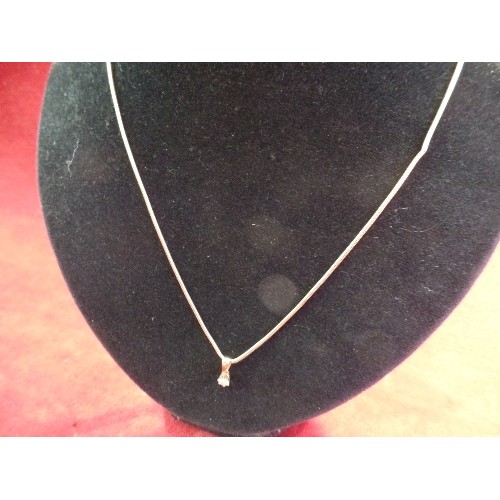 38 - A DIAMOND SOLITAIRE PENDANT (.25 CARAT) WITH 18CT GOLD SETTING AND BALE ON A SILVER GILT SNAKE CHAIN... 